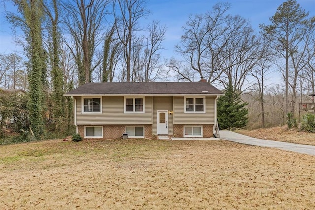 bi-level home with a front lawn