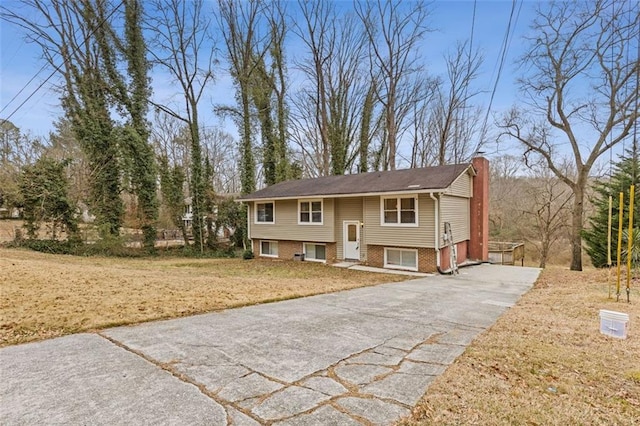 raised ranch featuring a front lawn