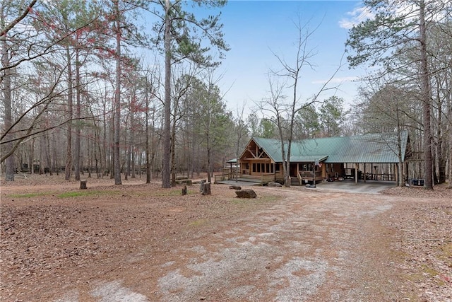 view of yard with dirt driveway and a porch