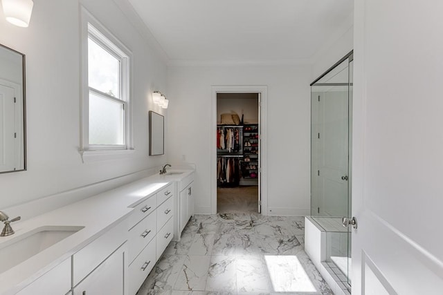 full bath featuring a sink, marble finish floor, a spacious closet, and a shower stall