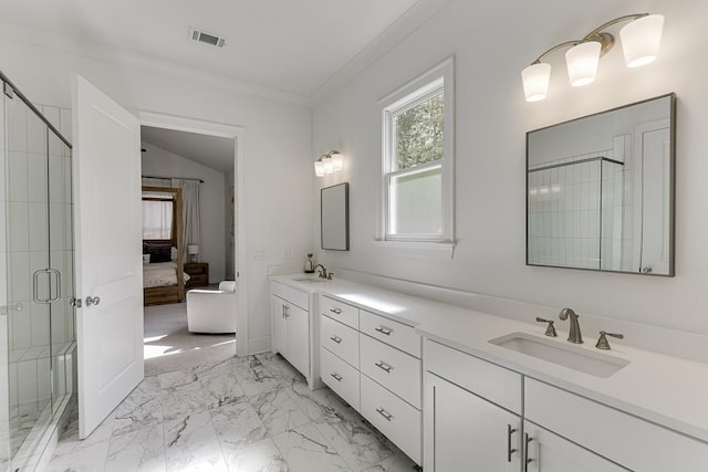 ensuite bathroom featuring double vanity, a shower stall, a sink, marble finish floor, and ensuite bathroom