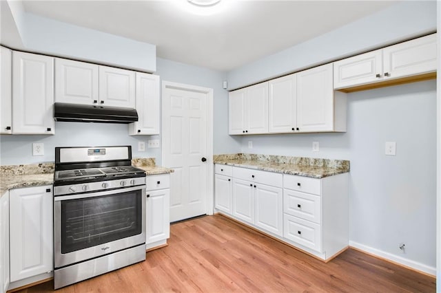 8914 Gardener Dr, Jonesboro, GA 30238 - kitchen featuring gas stove, under cabinet range hood, light wood-style floors, and white cabinets