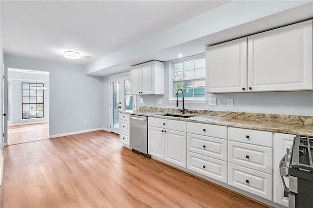 8914 Gardener Dr, Jonesboro, GA 30238 - kitchen featuring a sink, stainless steel appliances, white cabinetry, and light wood-style flooring