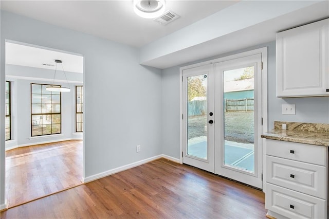 8914 Gardener Dr, Jonesboro, GA 30238 - doorway to outside with light wood-type flooring, french doors, and baseboards