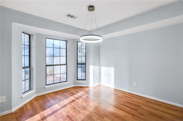 8914 Gardener Dr, Jonesboro, GA 30238 - spare room featuring wood finished floors, plenty of natural light, and baseboards