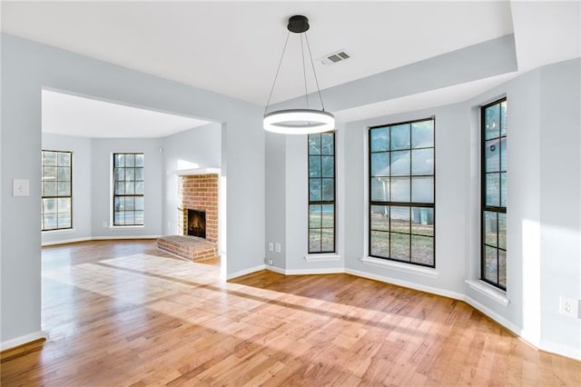 8914 Gardener Dr, Jonesboro, GA 30238 - unfurnished living room featuring light wood finished floors, baseboards, and a brick fireplace