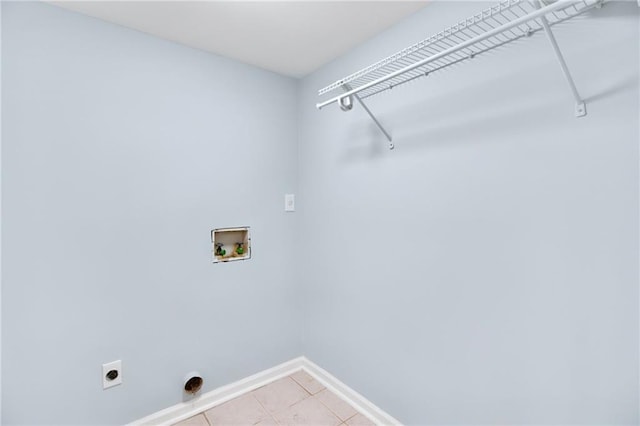 8914 Gardener Dr, Jonesboro, GA 30238 - laundry area with baseboards, light tile patterned floors, hookup for a washing machine, and hookup for an electric dryer