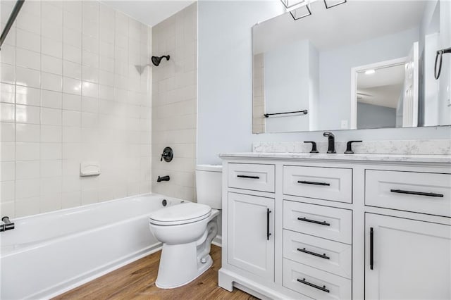 8914 Gardener Dr, Jonesboro, GA 30238 - full bath with toilet, wood finished floors, vanity, and bathtub / shower combination