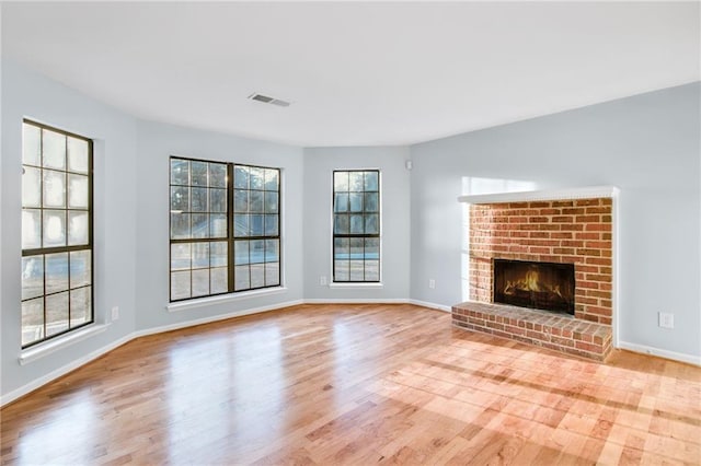 8914 Gardener Dr, Jonesboro, GA 30238 - unfurnished living room featuring wood finished floors, a fireplace, and baseboards