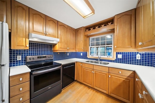 kitchen featuring dishwasher, sink, backsplash, white refrigerator, and stainless steel electric range