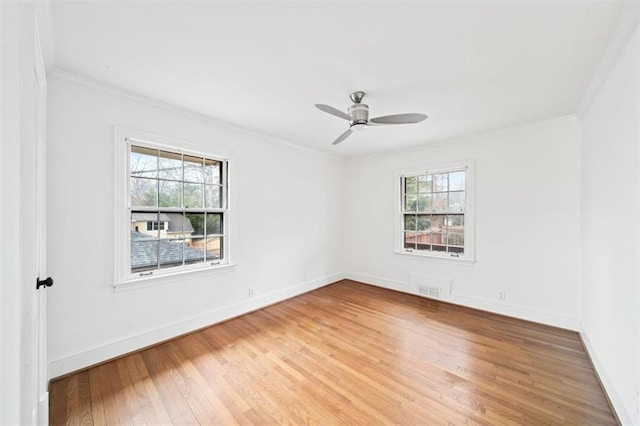 spare room with hardwood / wood-style floors, crown molding, and ceiling fan