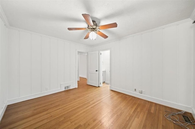 unfurnished room featuring crown molding, ceiling fan, and light hardwood / wood-style flooring