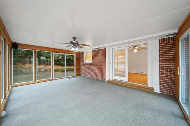 unfurnished sunroom with ceiling fan