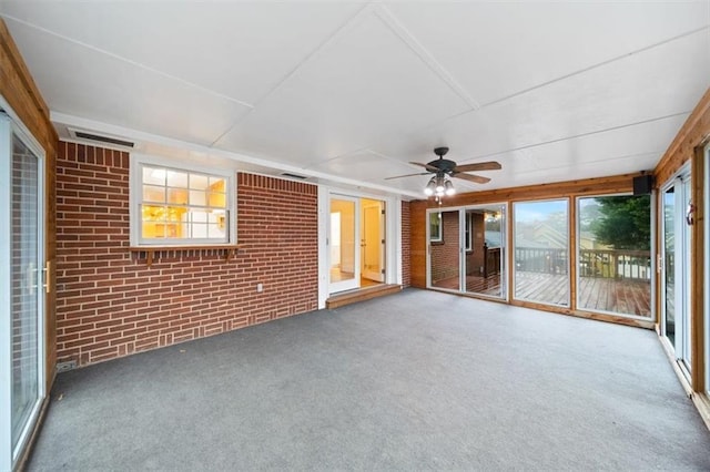 unfurnished sunroom featuring ceiling fan