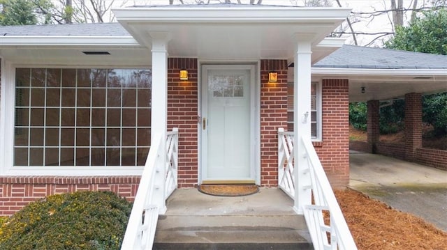 doorway to property with a carport