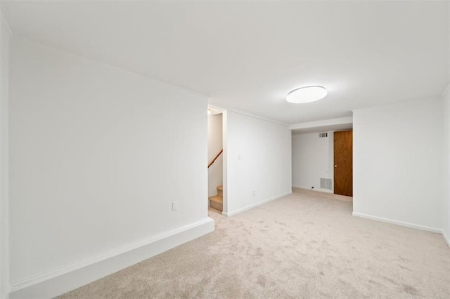 empty room featuring light colored carpet