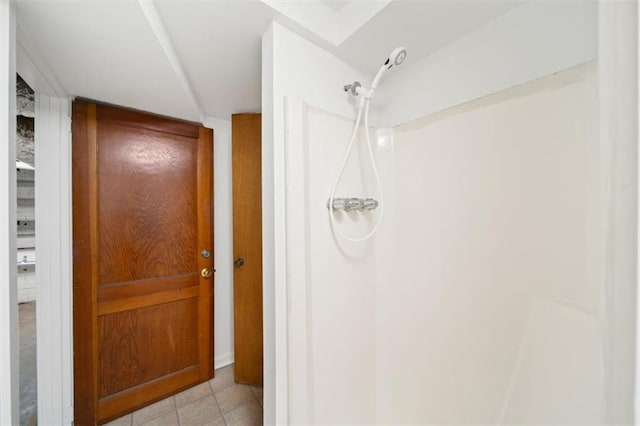 bathroom with tile patterned flooring and walk in shower