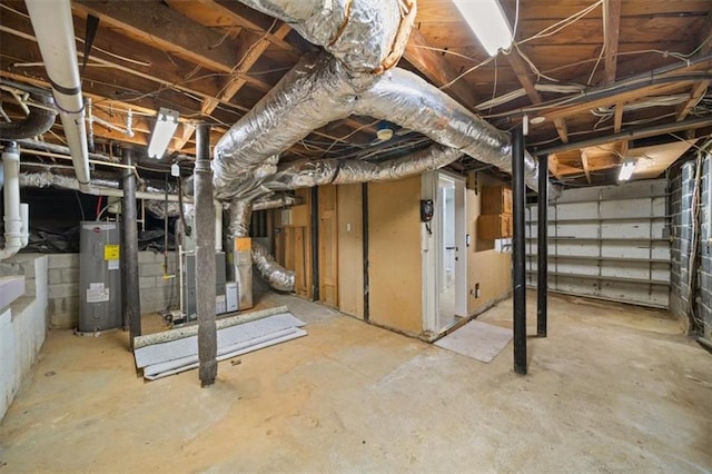 basement featuring electric water heater and heating unit