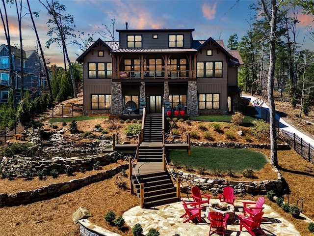 back house at dusk with a fire pit