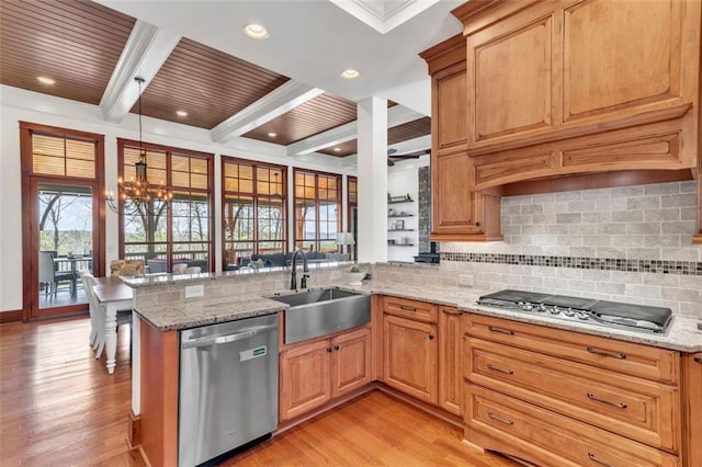 kitchen with stainless steel appliances, light stone counters, and tasteful backsplash