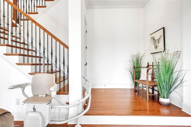 entrance foyer with ornamental molding and hardwood / wood-style flooring