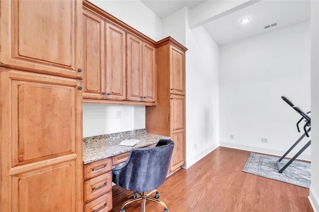 office featuring wood-type flooring and built in desk