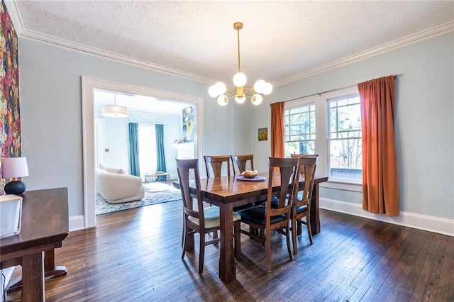 dining space featuring ornamental molding, dark hardwood / wood-style floors, a chandelier, and a textured ceiling