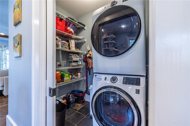 laundry area with stacked washing maching and dryer