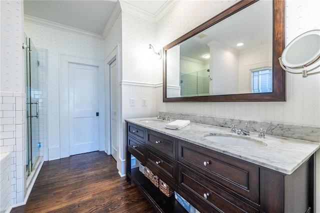 bathroom with walk in shower, ornamental molding, vanity, and wood-type flooring