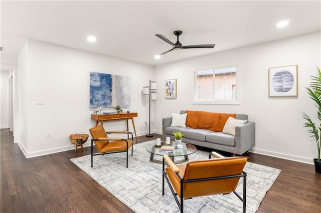 living room featuring ceiling fan and dark wood-type flooring