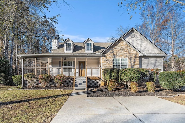 view of front of property with covered porch and a front lawn