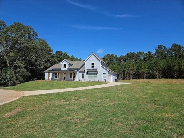 view of front facade featuring a front lawn, concrete driveway, and a garage