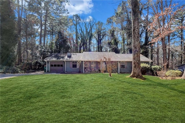 ranch-style home featuring a garage, driveway, and a front yard