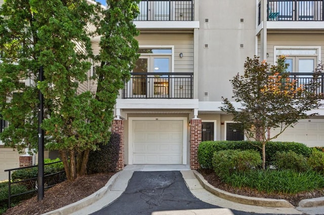 4254 River Green Dr Unit 613, Atlanta, GA 30327 - view of front of house with a balcony, an attached garage, brick siding, and stucco siding