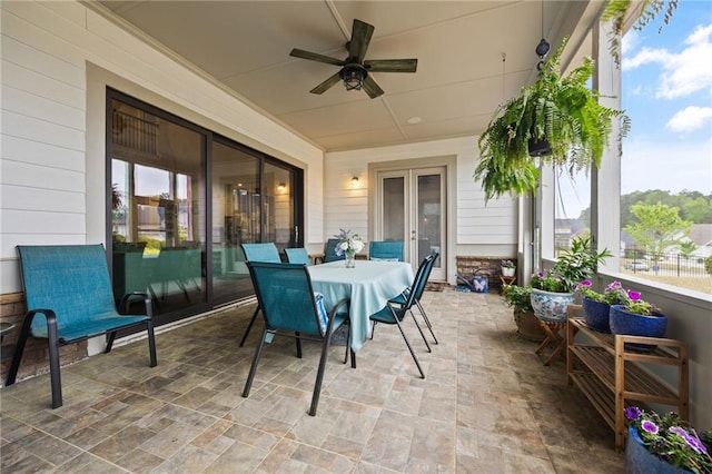 view of patio with ceiling fan, fence, french doors, and outdoor dining space