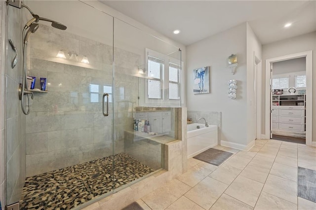 full bath featuring recessed lighting, tile patterned floors, a shower stall, and a garden tub