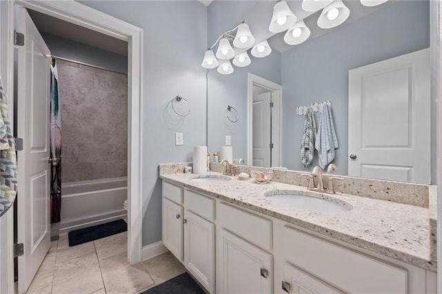 full bath with a sink, tile patterned floors, baseboards, and double vanity