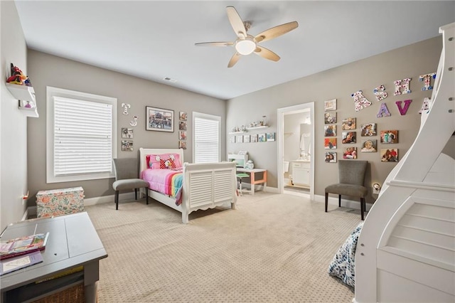 carpeted bedroom with connected bathroom, a ceiling fan, baseboards, and visible vents