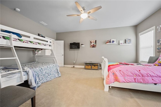 carpeted bedroom with baseboards and a ceiling fan