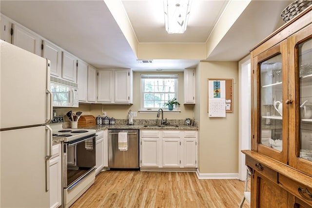 1750 Clairmont Rd Unit 35, Decatur, GA 30033 - kitchen featuring white appliances, a sink, light wood-style flooring, and white cabinets