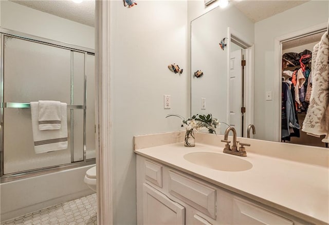1750 Clairmont Rd Unit 35, Decatur, GA 30033 - bathroom with a textured ceiling, vanity, toilet, and shower / bath combination with glass door