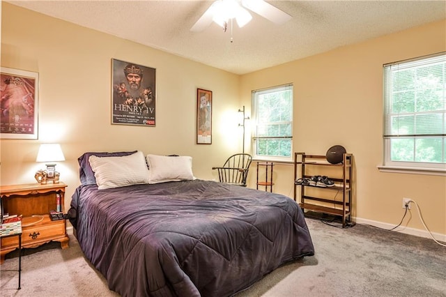 1750 Clairmont Rd Unit 35, Decatur, GA 30033 - bedroom featuring multiple windows, carpet floors, a textured ceiling, baseboards, and ceiling fan