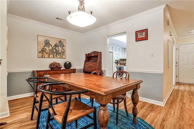 1750 Clairmont Rd Unit 35, Decatur, GA 30033 - dining area featuring crown molding, light wood-style flooring, and baseboards