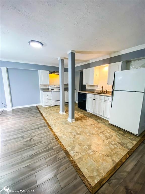 kitchen with white cabinets, light wood-type flooring, white appliances, and sink