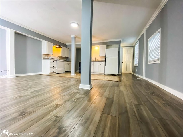 unfurnished living room featuring crown molding and light hardwood / wood-style flooring