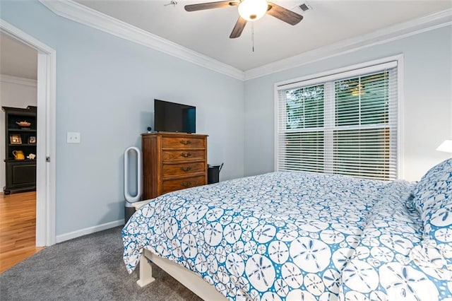 bedroom featuring ornamental molding, baseboards, ceiling fan, and carpet