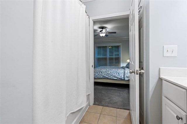 full bathroom featuring tile patterned flooring, ceiling fan, vanity, ensuite bathroom, and a shower with curtain
