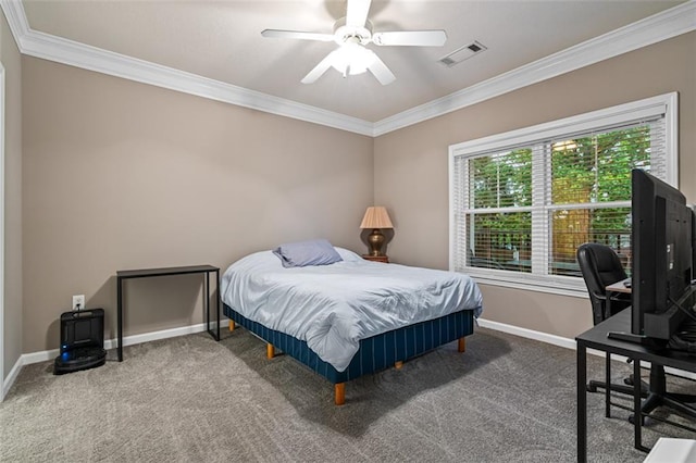 carpeted bedroom featuring crown molding, baseboards, a ceiling fan, and a desk