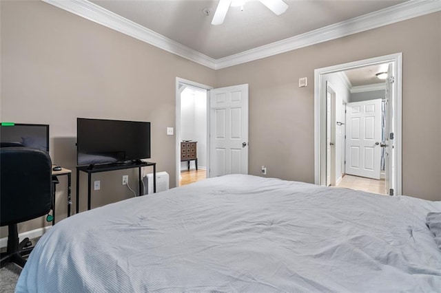bedroom featuring crown molding, attic access, baseboards, and ceiling fan