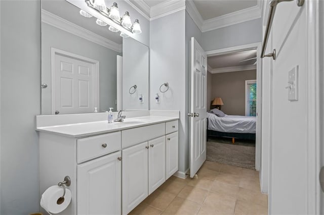 ensuite bathroom with ornamental molding, tile patterned flooring, and vanity